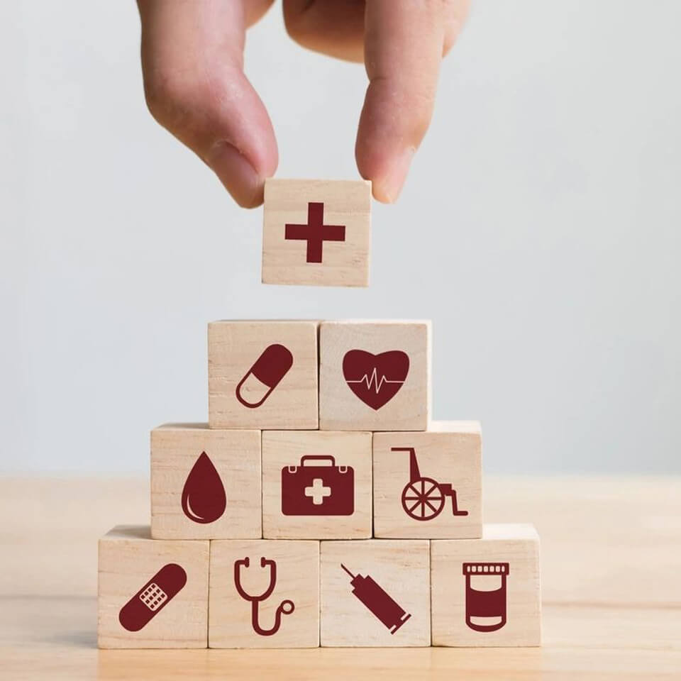 Hand Arranging Wood Block Stacking With Icon Healthcare Medical, Insurance for Your Health Concept